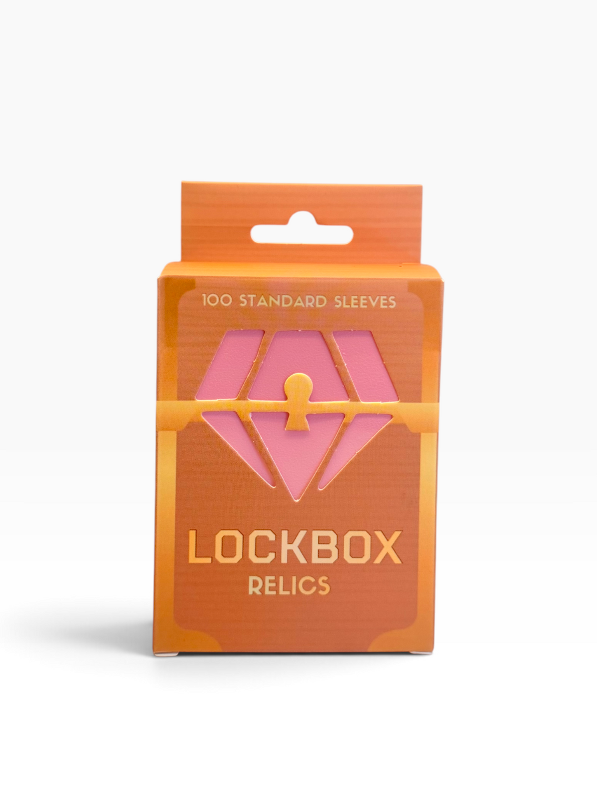 A retail package of Lockbox Relics containing 100 standard sleeves, featuring a bright orange cardboard box with a pink diamond-shaped graphic and gold lettering.